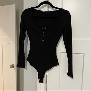Black ribbed long sleeve bodysuit with snap front detail and snap closure